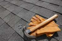 Shingles, Hammer and Nails on an Asphalt Shingle Roof